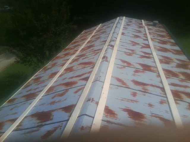 Rusted metal roof panels with new wood purlins before replacement — Storm Damage Roof Repair in Woodacre by Roofing Brothers