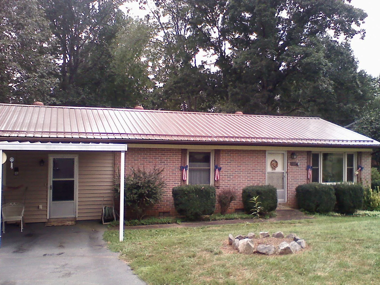 Bronze metal roof and carport on a brick ranch home — Roof Repair work by our crew in Woodacre